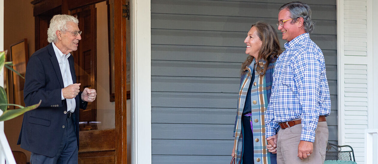 Jack Fine meets with two clients in front of the Gainesville, FL Office.